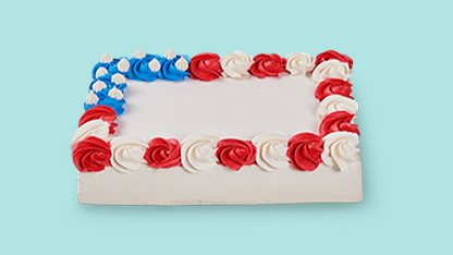 " patriotic cake with white frosting and red roses, cut into squares."